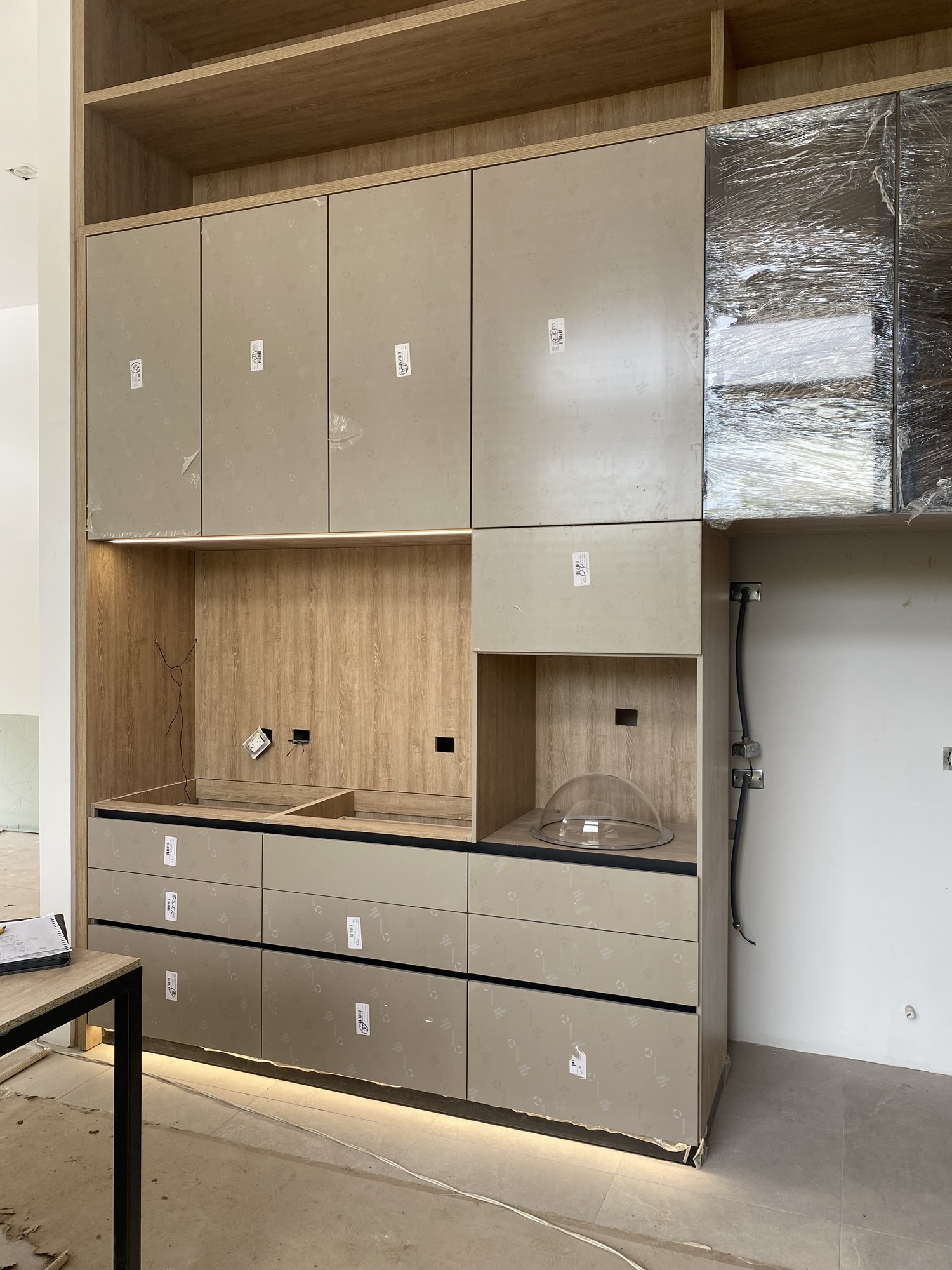 Cocina moderna con mobiliario superior en madera y diseño limpio con integración de almacenamiento